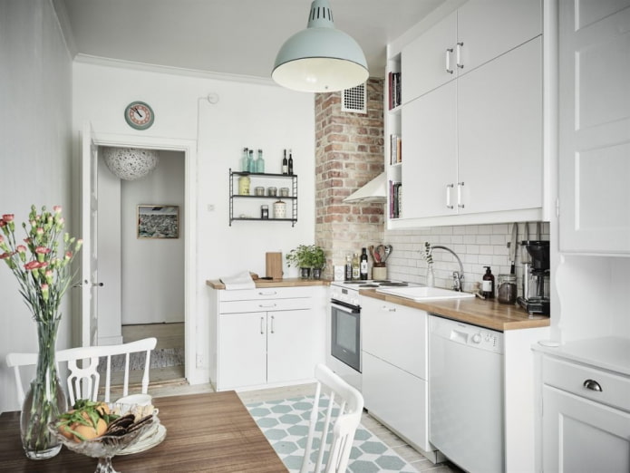 Cucina bianca con scatola di ventilazione rifinita in mattoni