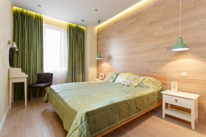 letto con copriletto verde in la camera da letto