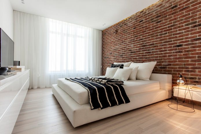 Carta da parati in mattoni rossi nel design della camera da letto